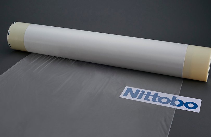 A roll of Nittobo glass cloth, a fine translucent fabric, with the Nittobo label on it.